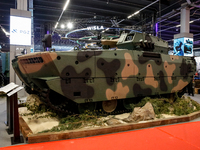 Visitors look at exhibitions of Polish Armaments Group (PGZ) as they attend the 32nd International Defence Industry Exhibition - MSPO i Targ...