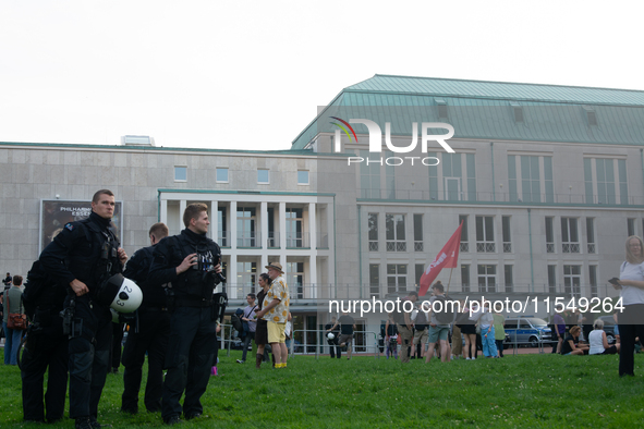 Police force guards the AFD event area as thousands of people take part in a demonstration against the AF politician event for community dia...