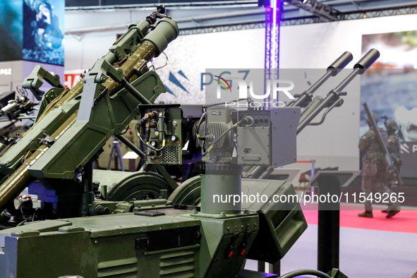 Visitors look at exhibitions of Polish Armaments Group (PGZ) as they attend the 32nd International Defence Industry Exhibition - MSPO i Targ...