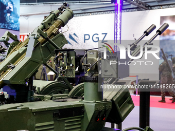 Visitors look at exhibitions of Polish Armaments Group (PGZ) as they attend the 32nd International Defence Industry Exhibition - MSPO i Targ...