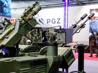 Visitors look at exhibitions of Polish Armaments Group (PGZ) as they attend the 32nd International Defence Industry Exhibition - MSPO i Targ...