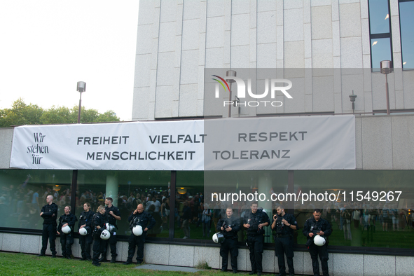 A banner reading ''Freedom, diversity and respect, human rights and tolerance'' hangs on the other buildings of Essen Philharmonie as thousa...