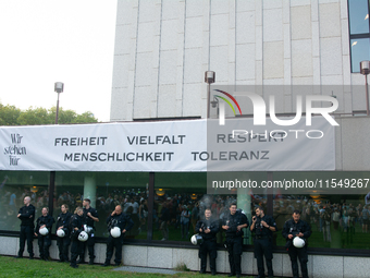 A banner reading ''Freedom, diversity and respect, human rights and tolerance'' hangs on the other buildings of Essen Philharmonie as thousa...