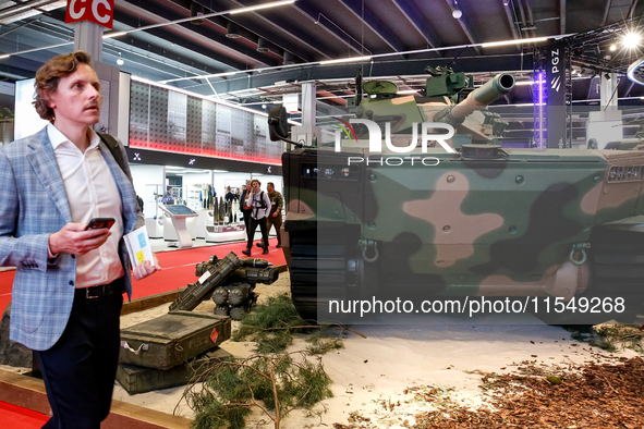 Visitors look at exhibitions of Polish Armaments Group (PGZ) as they attend the 32nd International Defence Industry Exhibition - MSPO i Targ...