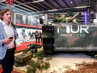 Visitors look at exhibitions of Polish Armaments Group (PGZ) as they attend the 32nd International Defence Industry Exhibition - MSPO i Targ...