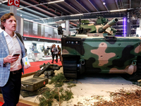 Visitors look at exhibitions of Polish Armaments Group (PGZ) as they attend the 32nd International Defence Industry Exhibition - MSPO i Targ...