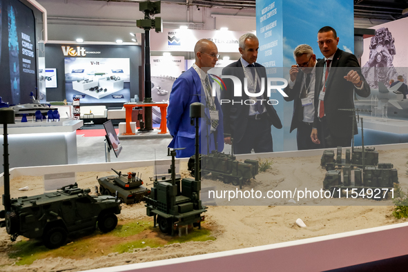 Visitors look at exhibitions as they attend the 32nd International Defence Industry Exhibition - MSPO i Targi Kielce in central Poland on Se...