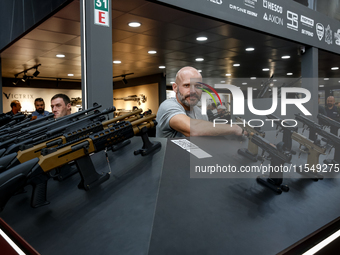 A presenter stands in UM Pavilion 32nd International Defence Industry Exhibition - MSPO i Targi Kielce in central Poland on September 5, 202...