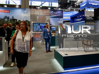 Visitors walk in BAE Systems Pavilion as they attend the 32nd International Defence Industry Exhibition - MSPO i Targi Kielce in central Pol...