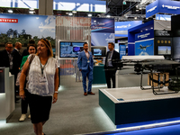 Visitors walk in BAE Systems Pavilion as they attend the 32nd International Defence Industry Exhibition - MSPO i Targi Kielce in central Pol...