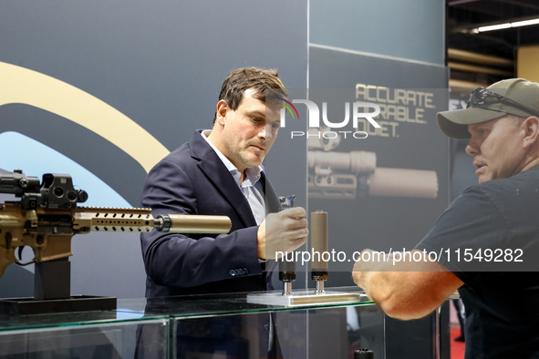 Visitors look at guns from Acheron Corp as they attend the 32nd International Defence Industry Exhibition - MSPO i Targi Kielce in central P...