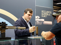 Visitors look at guns from Acheron Corp as they attend the 32nd International Defence Industry Exhibition - MSPO i Targi Kielce in central P...