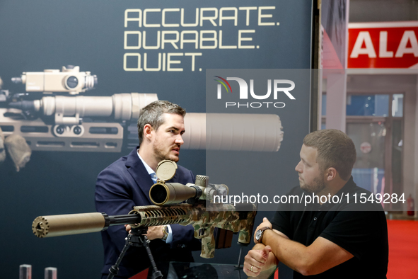 Visitors look at guns from Acheron Corp as they attend the 32nd International Defence Industry Exhibition - MSPO i Targi Kielce in central P...