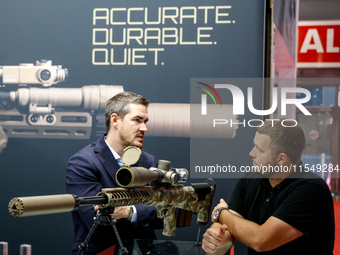 Visitors look at guns from Acheron Corp as they attend the 32nd International Defence Industry Exhibition - MSPO i Targi Kielce in central P...