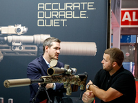 Visitors look at guns from Acheron Corp as they attend the 32nd International Defence Industry Exhibition - MSPO i Targi Kielce in central P...