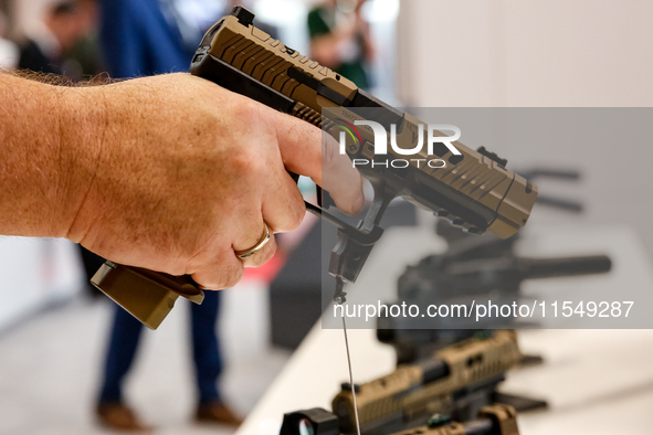 Visitors look at guns from Beretta Defence Technologies as they attend the 32nd International Defence Industry Exhibition - MSPO i Targi Kie...