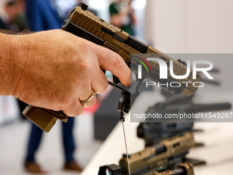 Visitors look at guns from Beretta Defence Technologies as they attend the 32nd International Defence Industry Exhibition - MSPO i Targi Kie...