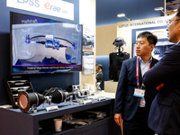 Visitors look at Korean armour systems as they attend the 32nd International Defence Industry Exhibition - MSPO i Targi Kielce in central Po...