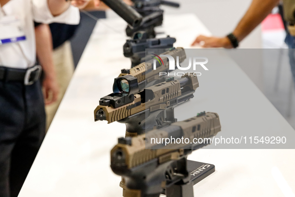 Visitors look at guns from Beretta Defence Technologies as they attend the 32nd International Defence Industry Exhibition - MSPO i Targi Kie...