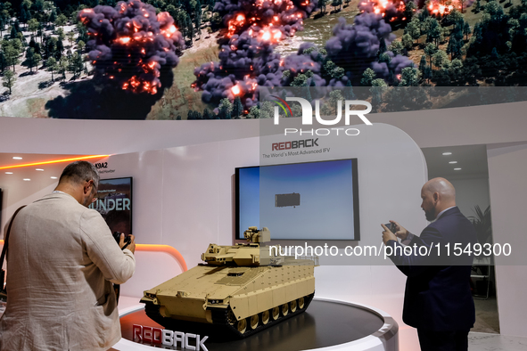 Visitors look at a model of Red Back tank from Hanwha as they attend the 32nd International Defence Industry Exhibition - MSPO i Targi Kielc...