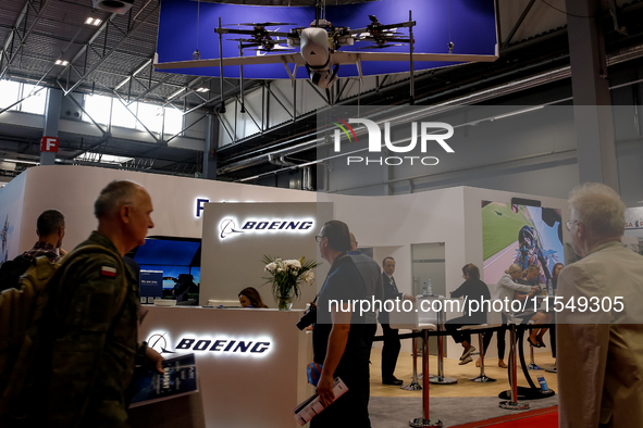 Visitors look at drones from Boeing as they attend the 32nd International Defence Industry Exhibition - MSPO i Targi Kielce in central Polan...