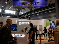 Visitors look at drones from Boeing as they attend the 32nd International Defence Industry Exhibition - MSPO i Targi Kielce in central Polan...