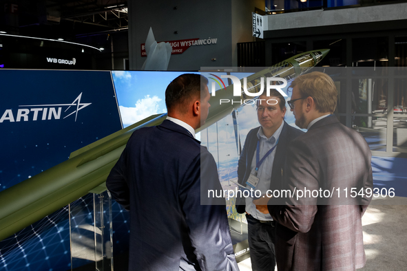 Visitors look at a missle from Lockheed Martin as they attend the 32nd International Defence Industry Exhibition - MSPO i Targi Kielce in ce...