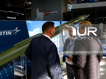 Visitors look at a missle from Lockheed Martin as they attend the 32nd International Defence Industry Exhibition - MSPO i Targi Kielce in ce...