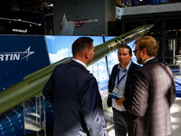 Visitors look at a missle from Lockheed Martin as they attend the 32nd International Defence Industry Exhibition - MSPO i Targi Kielce in ce...