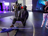 Visitor look at mannequin with a drone from WB Group as they attends the 32nd International Defence Industry Exhibition - MSPO i Targi Kielc...