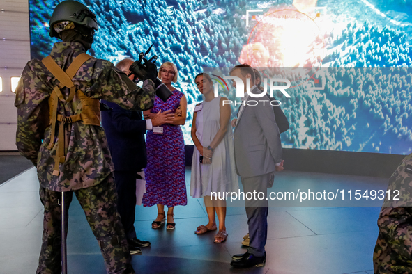 Visitor look at mannequin with a drone from WB Group as they attends the 32nd International Defence Industry Exhibition - MSPO i Targi Kielc...