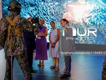 Visitor look at mannequin with a drone from WB Group as they attends the 32nd International Defence Industry Exhibition - MSPO i Targi Kielc...