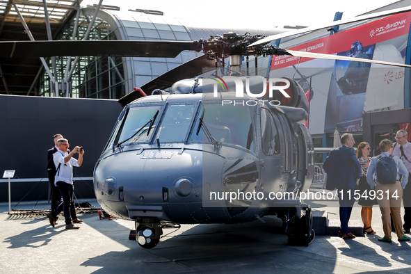 A visitor looks at Black Hawk helicopter as she attends the 32nd International Defence Industry Exhibition - MSPO i Targi Kielce in central...