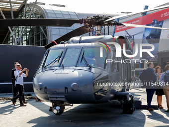 A visitor looks at Black Hawk helicopter as she attends the 32nd International Defence Industry Exhibition - MSPO i Targi Kielce in central...