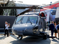 A visitor looks at Black Hawk helicopter as she attends the 32nd International Defence Industry Exhibition - MSPO i Targi Kielce in central...