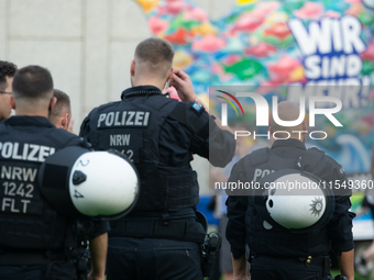 Police force guards the AFD event area as thousands of people take part in a demonstration against the AF politician event for community dia...