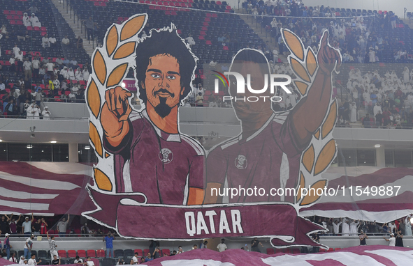 Qatar team supporters cheer for their team during the qualification 3rd round for the FIFA World Cup 2026 group A match between Qatar and Un...