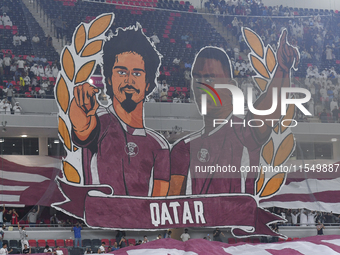 Qatar team supporters cheer for their team during the qualification 3rd round for the FIFA World Cup 2026 group A match between Qatar and Un...