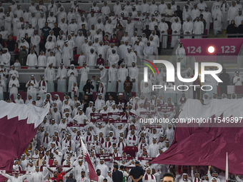 Qatar team supporters cheer for their team during the qualification 3rd round for the FIFA World Cup 2026 group A match between Qatar and Un...