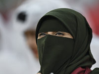 A fan of Qatar cheers during the qualification 3rd round for the FIFA World Cup 2026 group A match between Qatar and the United Arab Emirate...