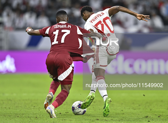 Ismail Mohamad of Qatar battles for the ball with Yahya Alghassan of the United Arab Emirates during the qualification 3rd round for the FIF...