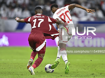 Ismail Mohamad of Qatar battles for the ball with Yahya Alghassan of the United Arab Emirates during the qualification 3rd round for the FIF...