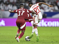 Ismail Mohamad of Qatar battles for the ball with Yahya Alghassan of the United Arab Emirates during the qualification 3rd round for the FIF...