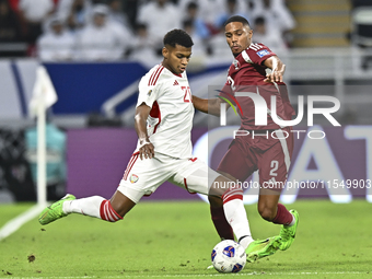 Pedro Correia of Qatar battles for the ball with Yahya Alghassani of the United Arab Emirates during the qualification 3rd round for the FIF...