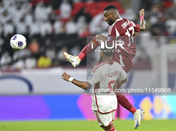 Ahmed Fathy of Qatar battles for the ball with Tahnoon Hamdan of the United Arab Emirates during the qualification 3rd round for the FIFA Wo...