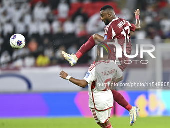 Ahmed Fathy of Qatar battles for the ball with Tahnoon Hamdan of the United Arab Emirates during the qualification 3rd round for the FIFA Wo...