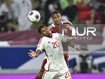 Pedro Correia of Qatar battles for the ball with Yahya Alghassani of the United Arab Emirates during the qualification 3rd round for the FIF...