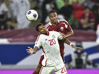 Pedro Correia of Qatar battles for the ball with Yahya Alghassani of the United Arab Emirates during the qualification 3rd round for the FIF...