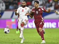 Jassem Gaber of Qatar battles for the ball with Tahnoon Hamdan of the United Arab Emirates during the qualification 3rd round for the FIFA W...