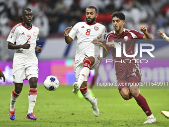 Jassem Gaber of Qatar battles for the ball with Tahnoon Hamdan of the United Arab Emirates during the qualification 3rd round for the FIFA W...